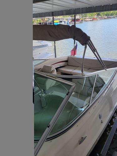 Maxum 2300 SR 2002 Maxum 2300 SR boat docked, featuring a sleek design and spacious seating area.