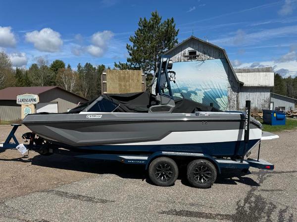 Nautique Super Air GS20 2024 Nautique Super Air GS20 boat on a trailer in a rural setting.