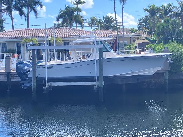 Grady-White Canyon 336 2020 Grady-White Canyon 336 boat docked by waterfront home with palm trees.