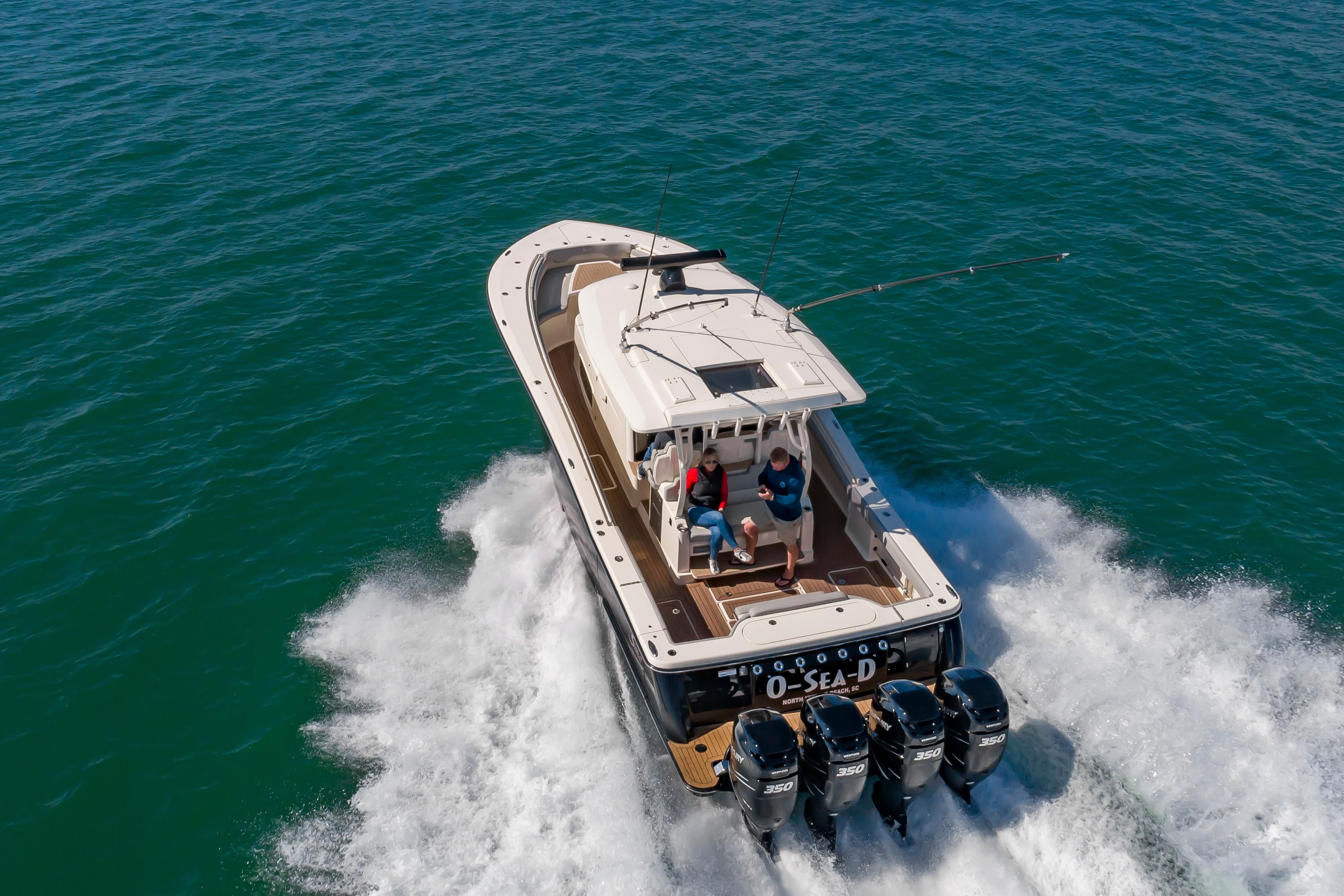 Scout 380 LXF 2020 Scout 380 LXF boat cruising on open water with four engines.