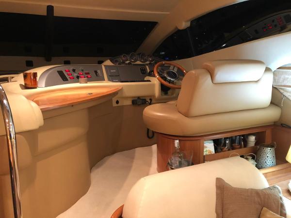 Azimut Fly 50 Luxurious interior of a 2008 Azimut Fly 50 yacht with elegant seating and control panel.