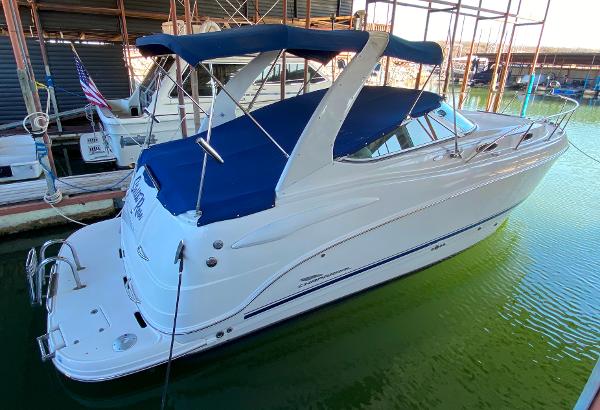 Chaparral 280 Signture 2003 Chaparral 280 Signature boat docked with blue canopy and sleek white design.
