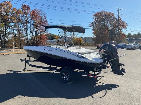 Tahoe T18 2025 Tahoe T18 boat on trailer in sunny parking lot.