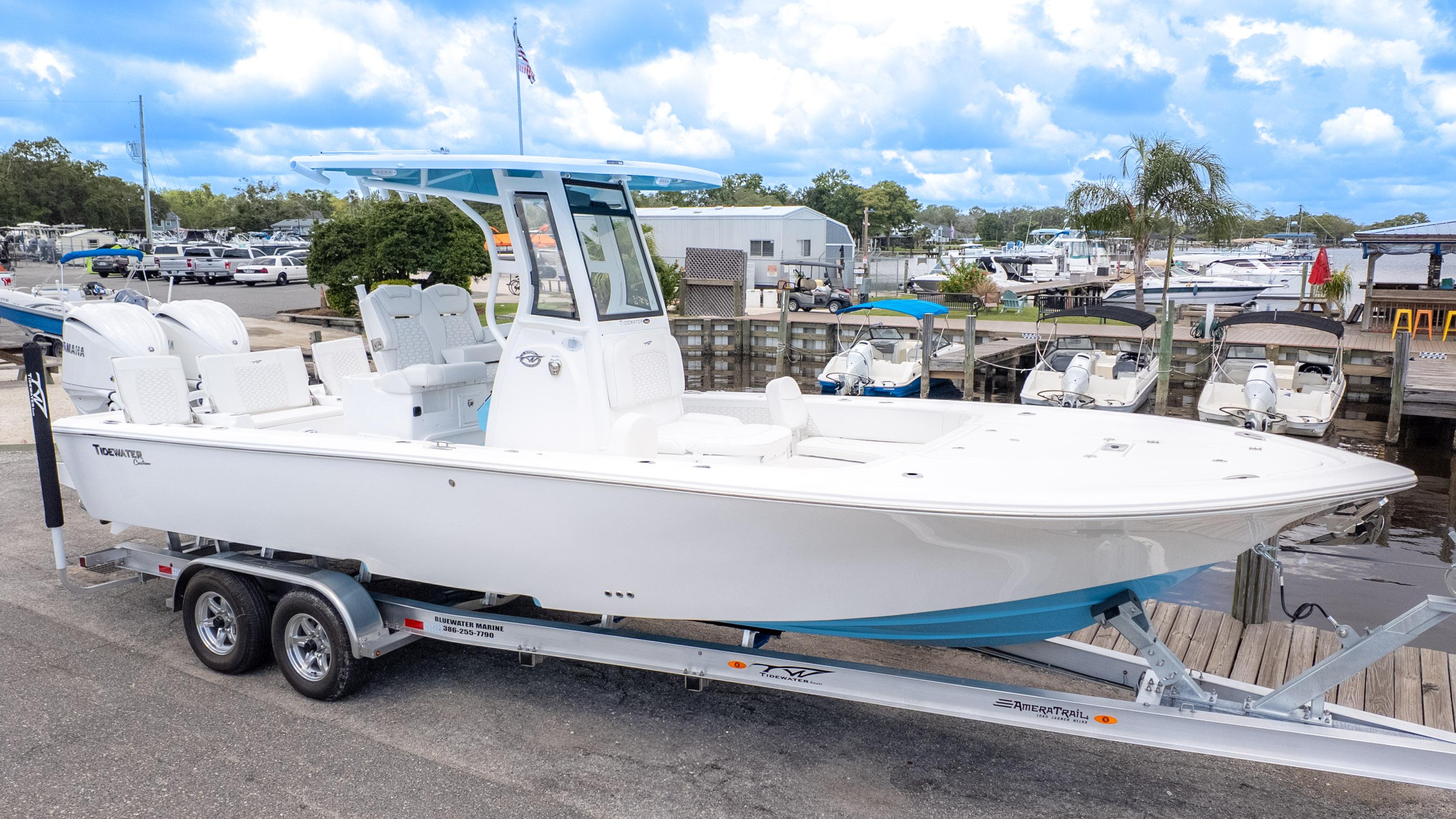 Tidewater 2700 Carolina Bay 2026 Tidewater 2700 Carolina Bay boat on trailer at marina, clear sky background.