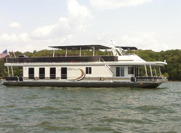 Sharpe 75' Houseboat 2003 Sharpe 75' Houseboat on a lake with trees in the background.