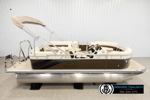 Avalon VLS QL 2026 Avalon VLS QL pontoon boat with beige seating and canopy in showroom.