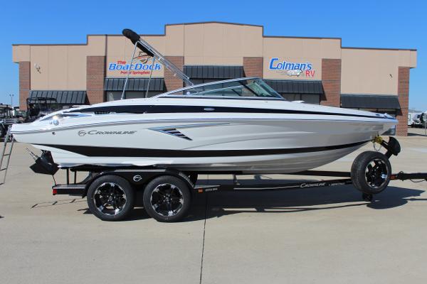Crownline 220 SS 2024 Crownline 220 SS boat on a trailer outside a dealership.