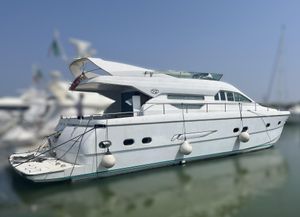 VZ 18 Luxury VZ 18 yacht from 1995 docked in a marina, side view.