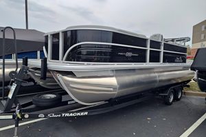 Sun Tracker Party Barge 22 XP3 2026 Sun Tracker Party Barge 22 XP3 pontoon boat on trailer in parking lot.