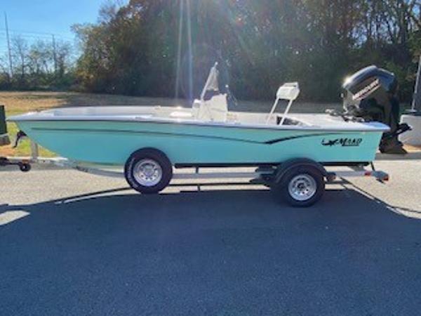 Mako Pro Skiff 17 CC 2024 Mako Pro Skiff 17 CC boat on trailer, side view in outdoor setting.