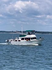 Albin 36 Trawler 1986 Albin 36 Trawler cruising on open water under a cloudy sky.