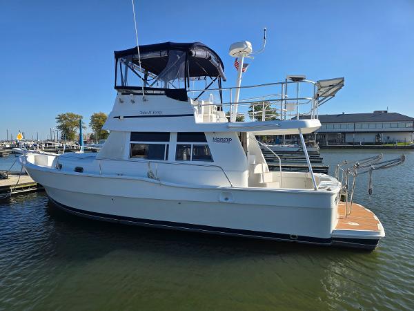 Mainship 350 Trawler 1997 Mainship 350 Trawler docked in a marina under clear blue skies.