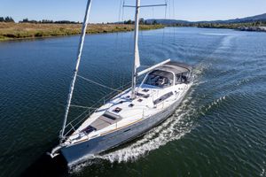 Beneteau Oceanis 50 2013 Beneteau Oceanis 50 sailing on a serene river under clear skies.