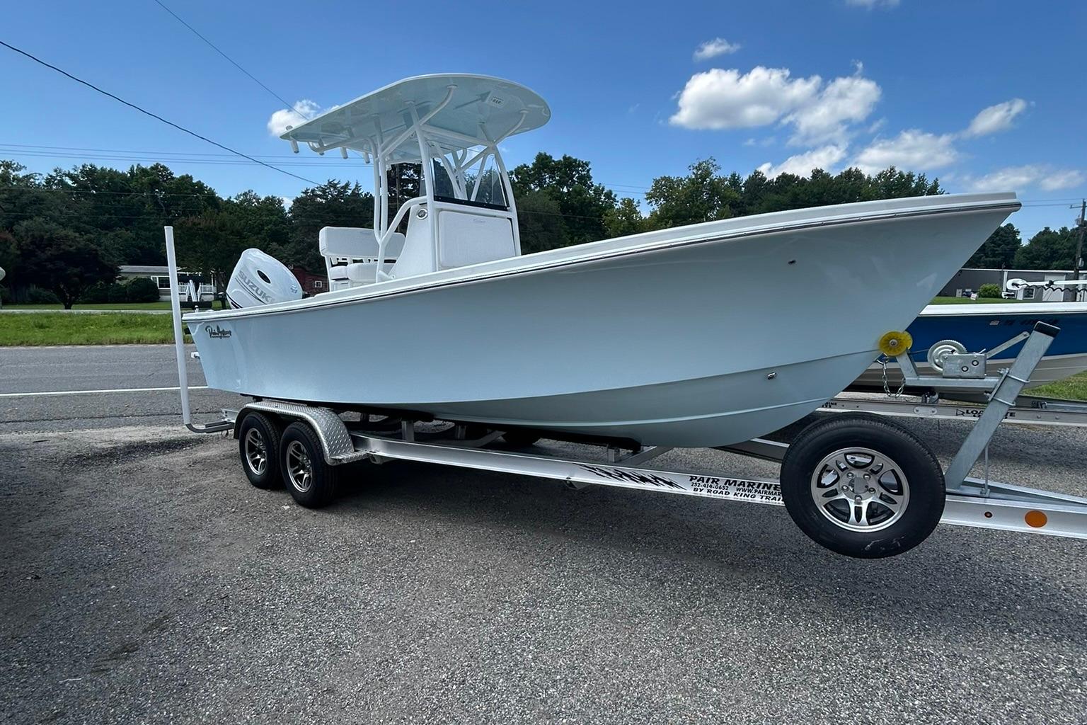 Pair Customs 21 Center Console MV 2026 Pair Customs 21 Center Console MV boat on trailer, parked roadside under blue sky.