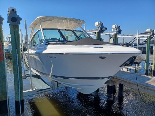 Pursuit DC 266 Dual Console 2024 Pursuit DC 266 Dual Console boat docked at marina under clear blue sky.