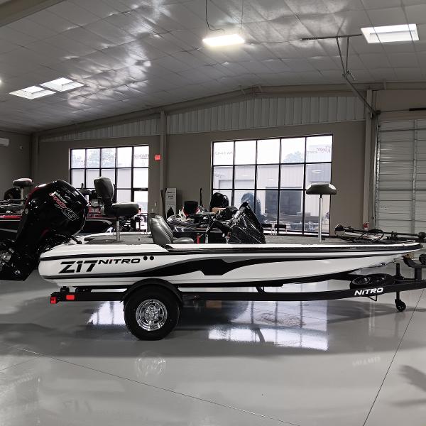 Nitro Z17 2025 Nitro Z17 boat in showroom, side view, sleek design, white and black color scheme.
