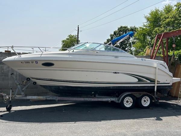 Sea Ray 245 Weekender 2001 Sea Ray 245 Weekender boat on trailer, parked outdoors.
