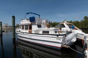 Marine Trader Double Cabin 1982 Marine Trader 44 Aft Cabin yacht docked in a marina under clear blue skies.