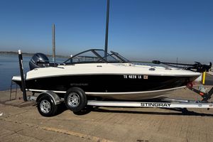 Stingray 192 DC 2023 Stingray 192 DC boat on trailer by the water, clear sky background.