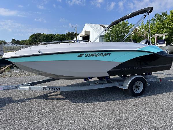 Starcraft SVX 171 OB 2025 Starcraft SVX 171 OB boat on a trailer in a parking lot.
