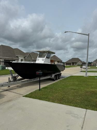 Custom Aluminum Center Console 2005 Custom Aluminum Center Console boat on trailer in suburban neighborhood.