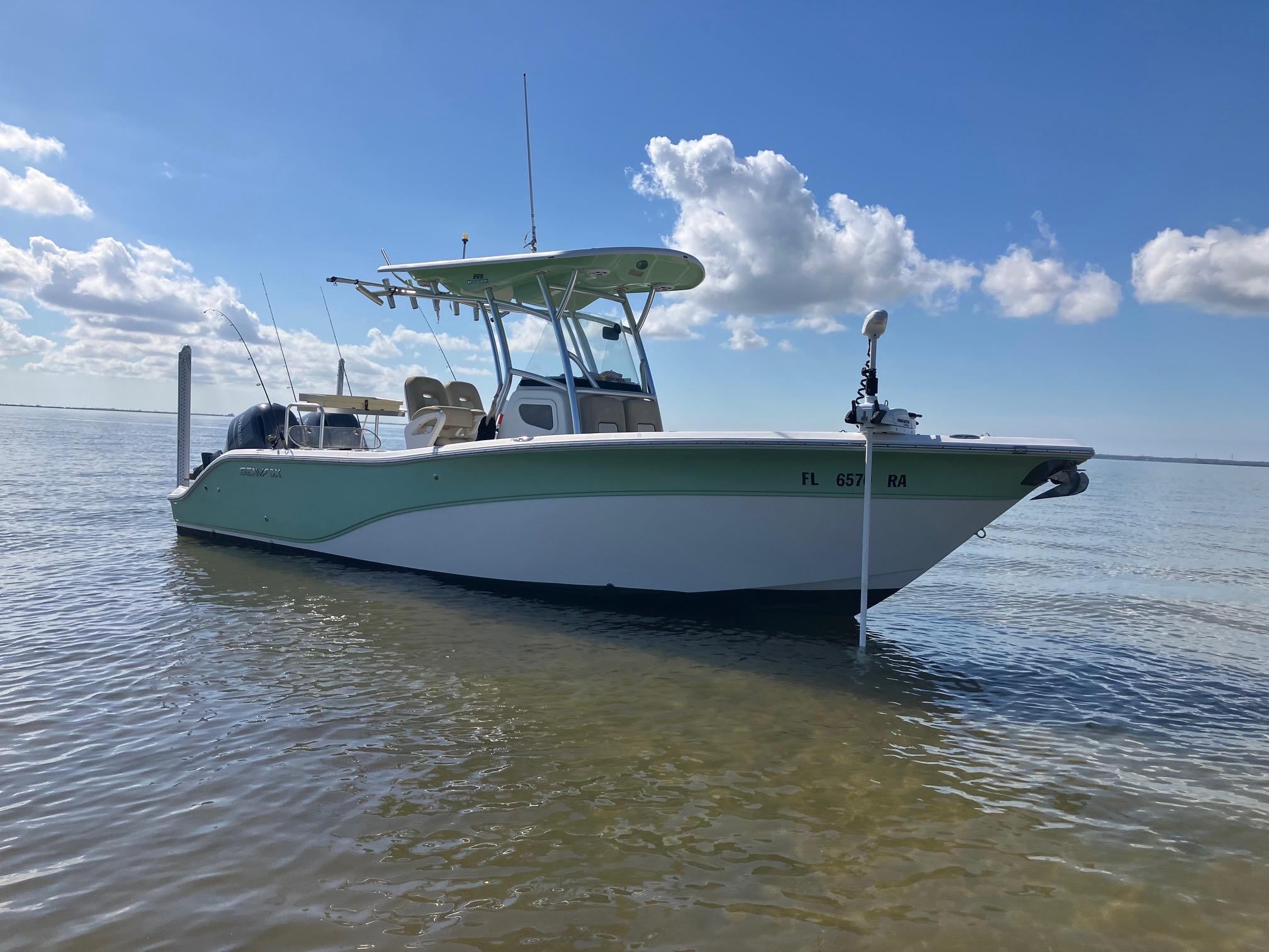 Sea Fox 266 Commander 2016 Sea Fox 266 Commander boat anchored in shallow water under a clear blue sky.