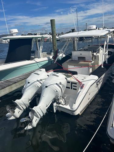 Pursuit S 280 Sport 2016 Pursuit S 280 Sport boat docked with twin outboard engines.
