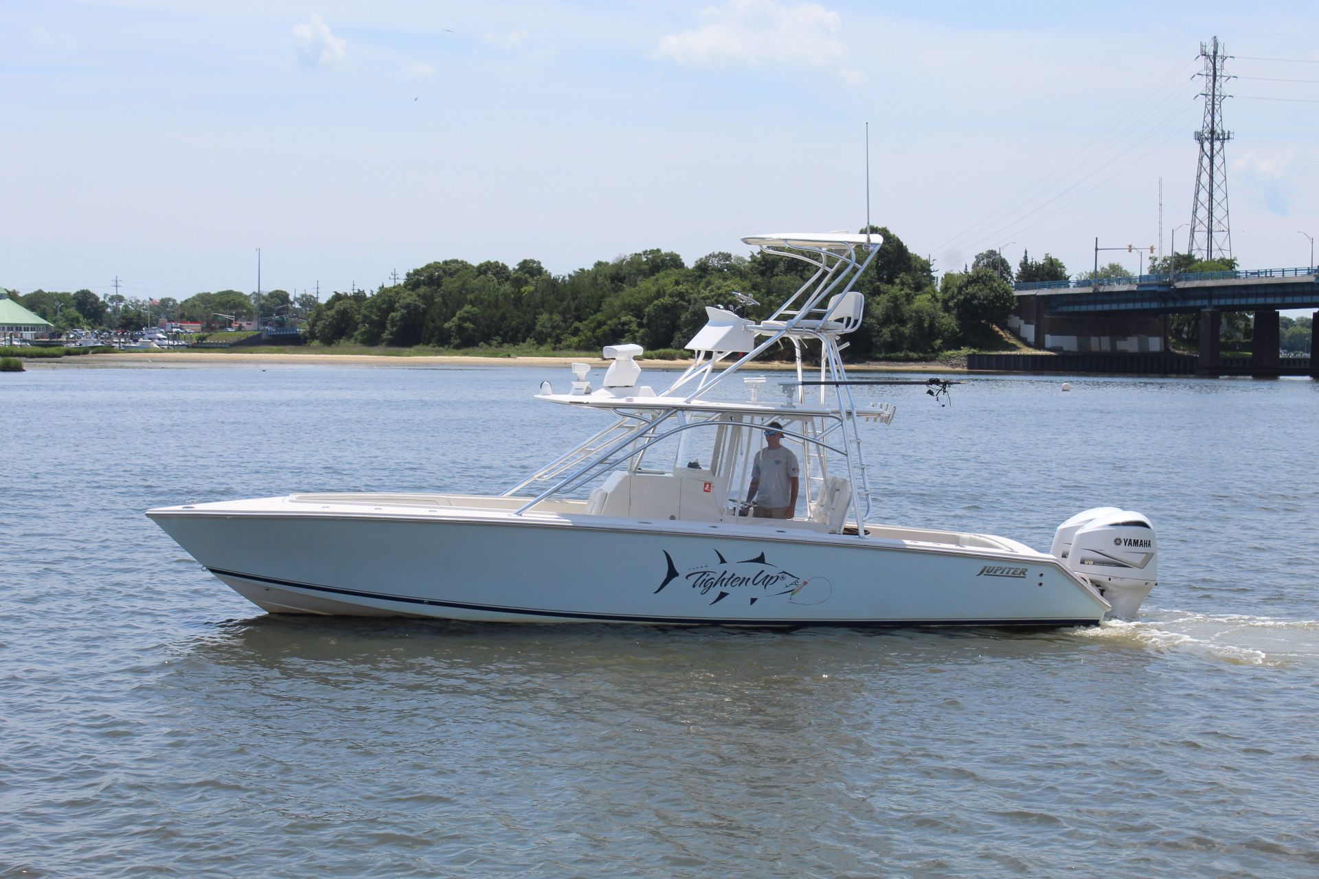 Jupiter 34 FS 2011 Jupiter 34 FS boat cruising on a calm river near a bridge.