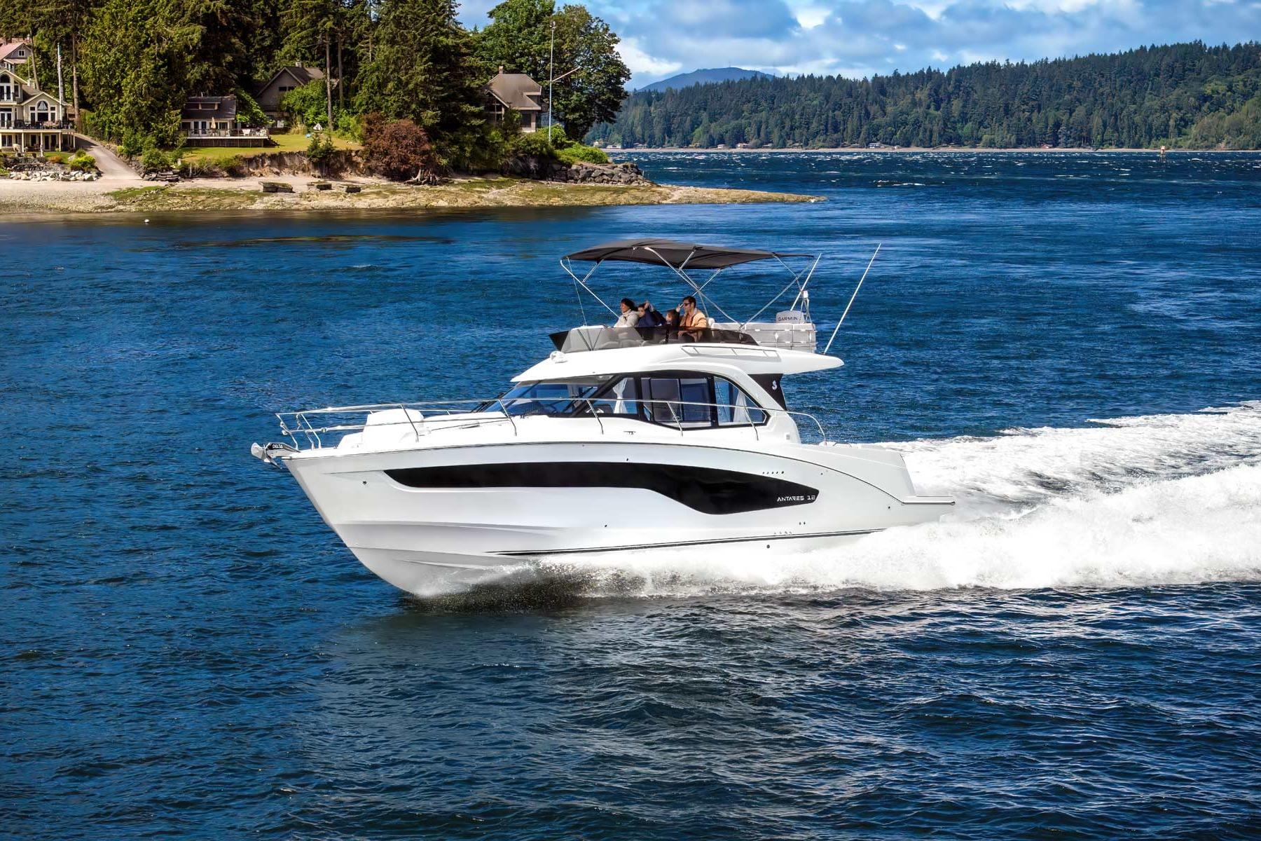 Beneteau Antares 12 Fly Sport 2025 Beneteau Antares 12 Fly Sport cruising on a scenic lake with lush shoreline.