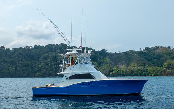 Custom Marcam 43 Convertible Custom Marcam 43 Convertible 2010 yacht on calm water with forested hills in the background.
