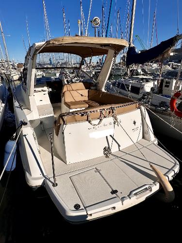 Jeanneau Leader 8 2012 Jeanneau Leader 8 boat docked in marina, featuring spacious deck and seating area.