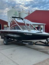 Moomba Mobius LS 2006 Moomba Mobius LS boat on trailer, parked near red building and silo.
