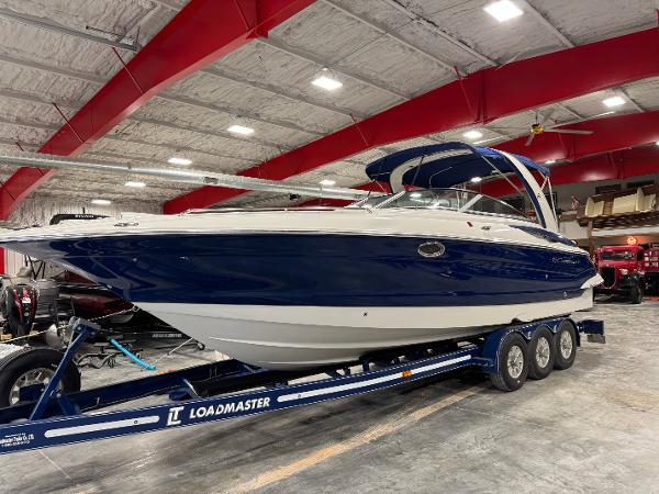 Crownline 325 SS 2012 Crownline 325 SS boat on Loadmaster trailer in indoor storage facility.