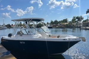 Pro-Line 23 Dual Console 2018 Pro-Line 23 Dual Console boat docked by a scenic waterfront.