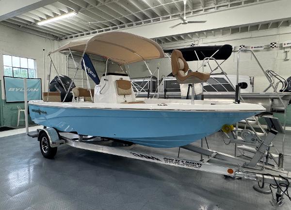 NauticStar 194 Bay 2024 NauticStar 194 Bay boat with canopy on trailer in showroom.