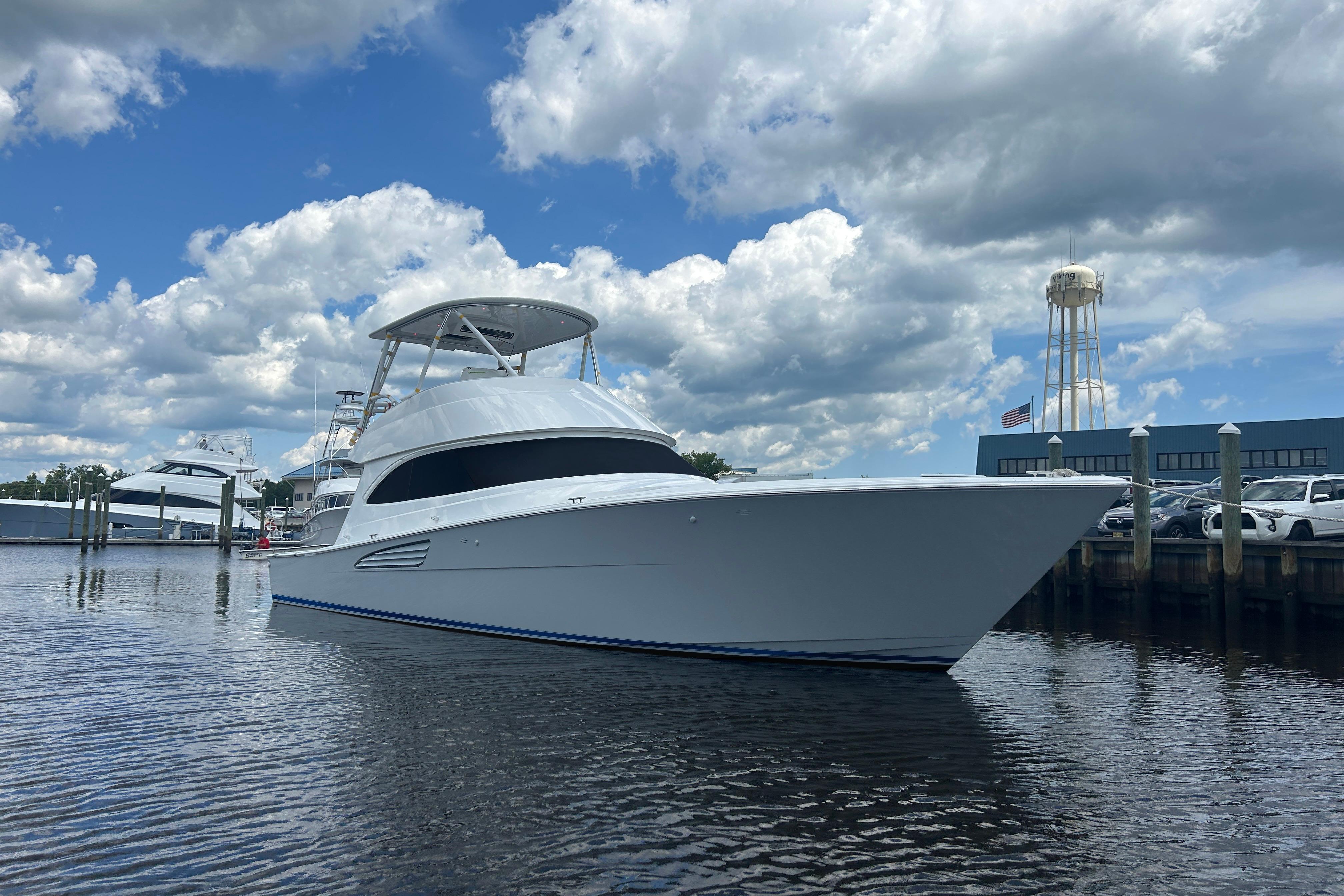 Viking 50 Convertible 2026 Viking 50 Convertible yacht docked under a cloudy sky.