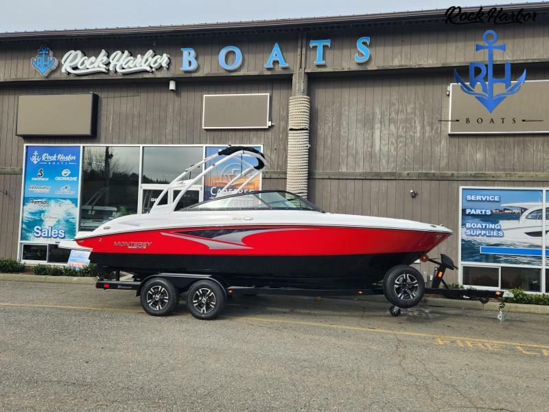 Monterey M-22 2023 Monterey M-22 boat in red and black on trailer outside Rock Harbor Boats.