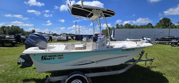 Carolina Skiff 178 DLV 2019 Carolina Skiff 178 DLV boat on trailer, parked on grass under blue sky.