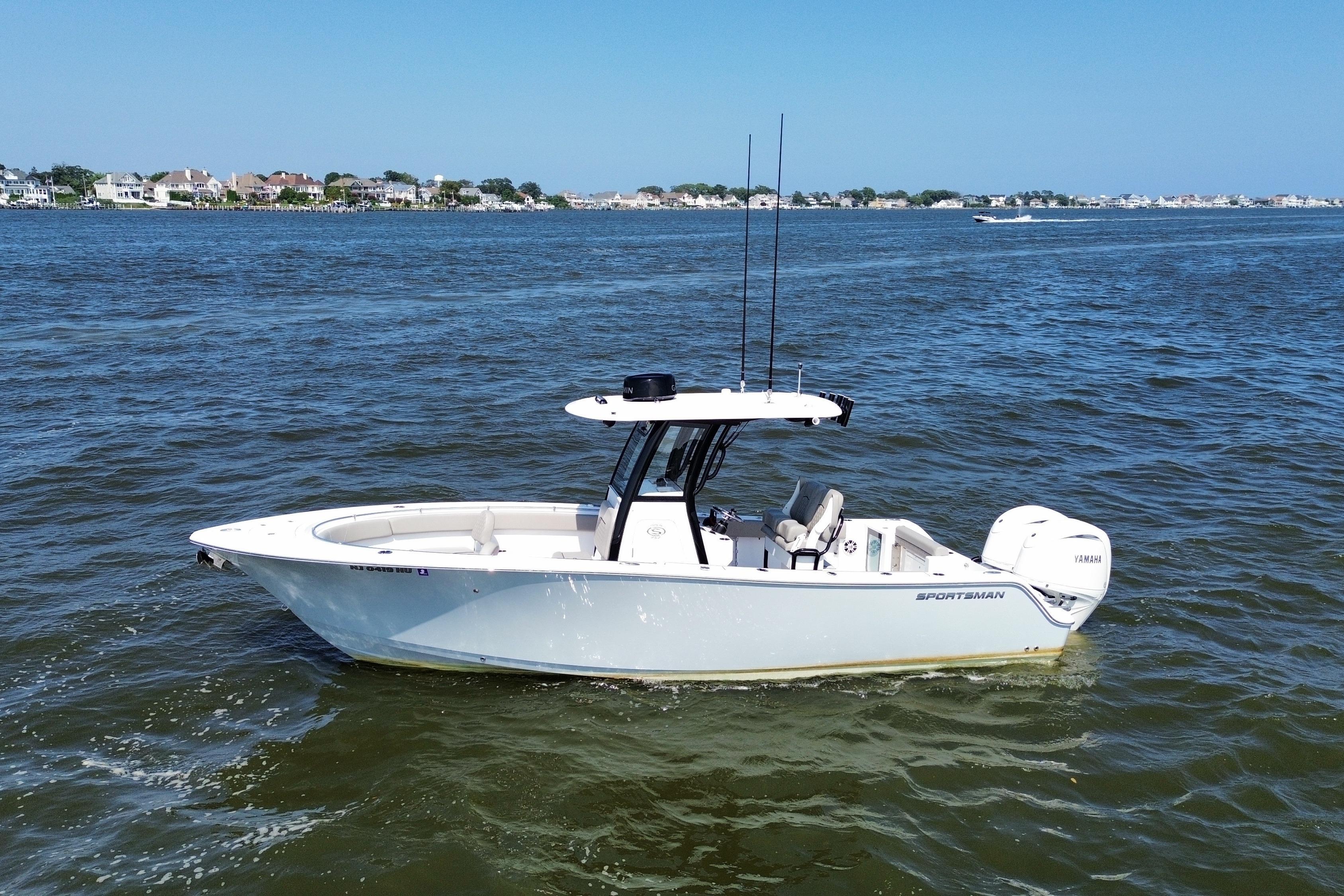 Sportsman Open 252 Center Console 2024 Sportsman Open 252 Center Console boat on calm water, coastal background.