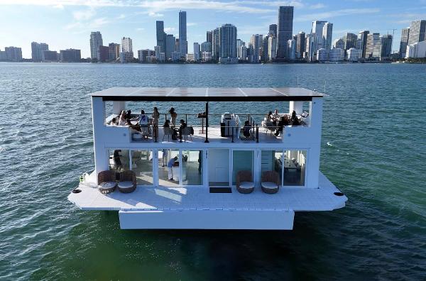 Custom Arkup 50 Floating luxury home, Arkup 50, on water with city skyline in background, 2025 model.