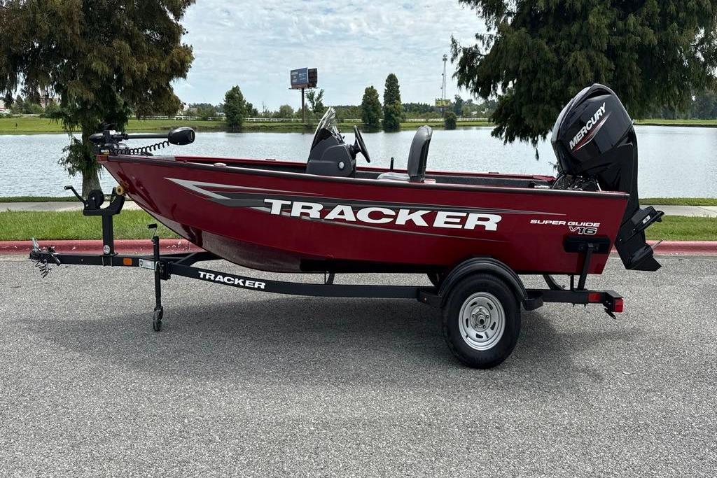 Tracker Super Guide V-16 SC 2026 Tracker Super Guide V-16 SC boat on trailer by a lake.