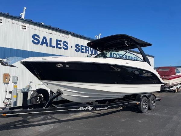 Sea Ray SLX 260 2024 Sea Ray SLX 260 boat on trailer outside sales and service building.