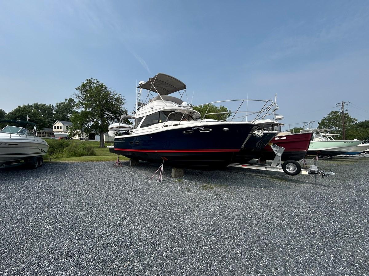 Cutwater C-32 CB 2022 Cutwater C-32 CB boat on trailer in outdoor storage area.
