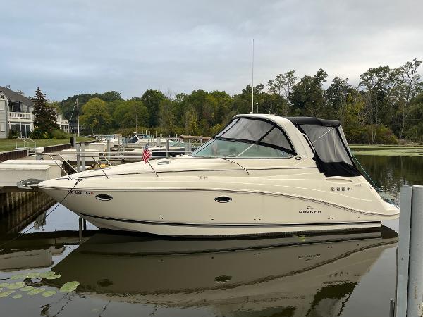 Rinker 330 Express Cruiser 2008 Rinker 330 Express Cruiser docked on a calm lake.