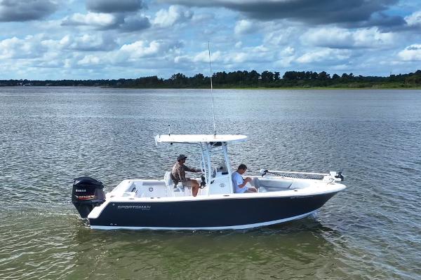 Sportsman Open 232 Center Console 2020 Sportsman Open 232 Center Console boat on calm water under cloudy sky.