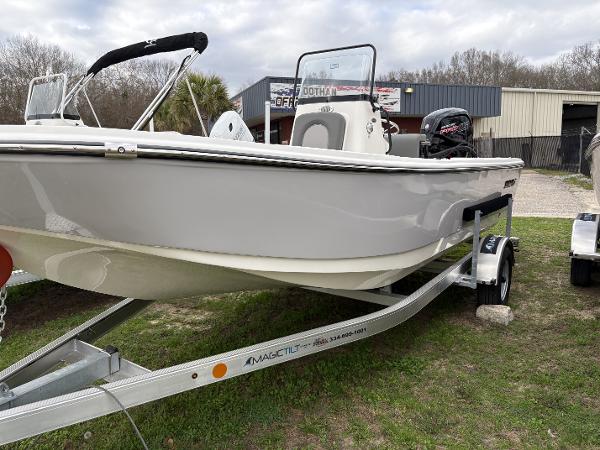 Sundance DX20 2024 Sundance DX20 boat on trailer, parked outdoors near a building.