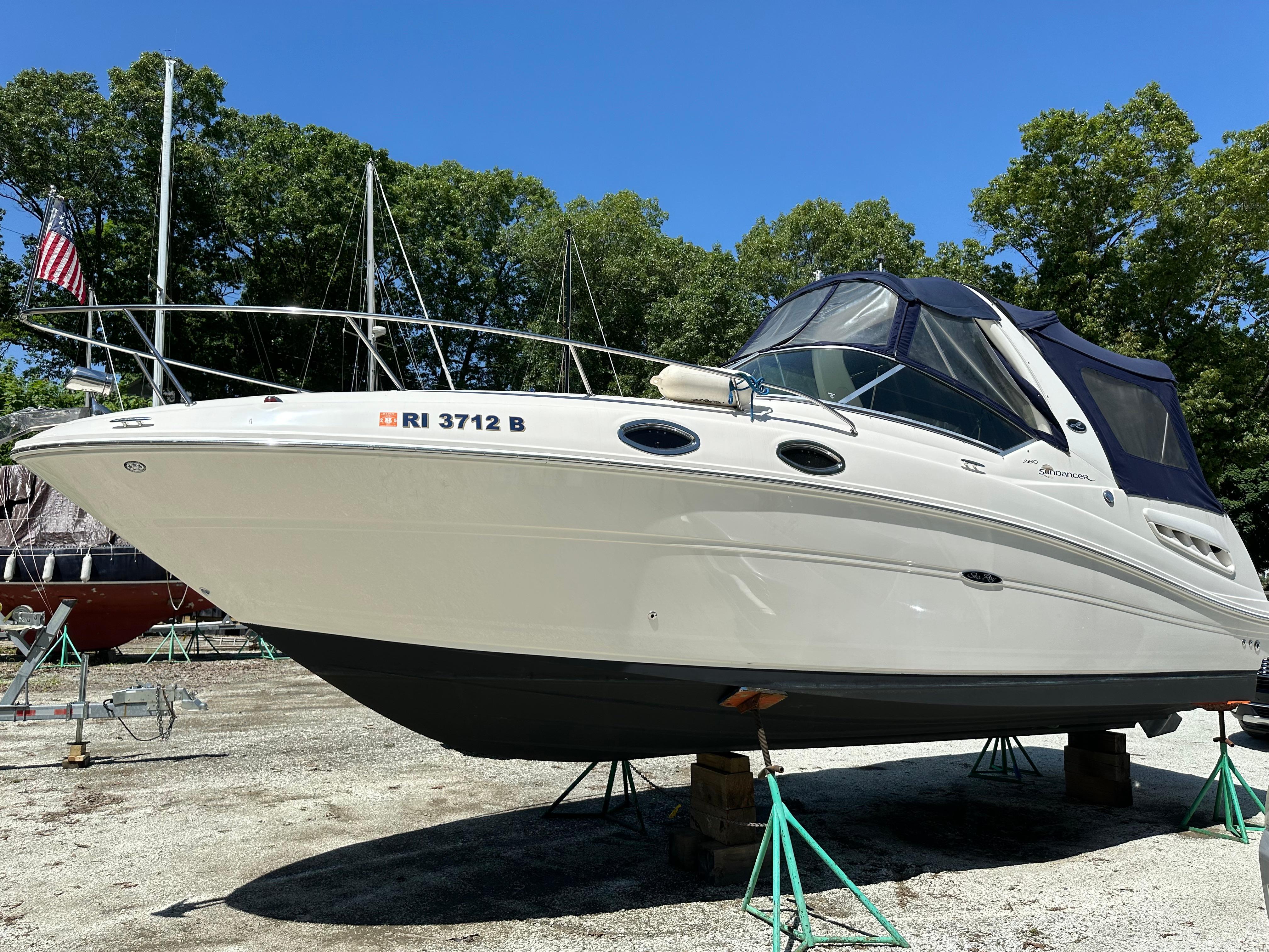 Sea Ray 260 Sundancer 2007 Sea Ray 260 Sundancer boat on stands, outdoors, with trees in the background.
