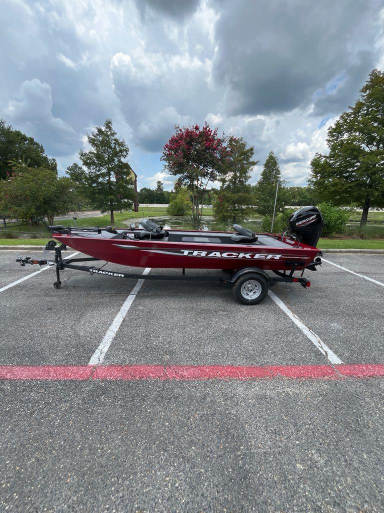 Tracker Panfish 17 2025 Tracker Panfish 17 boat on trailer in parking lot, cloudy sky background.