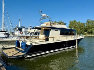 Targa 44 2016 Targa 44 yacht docked in a marina under clear blue skies.