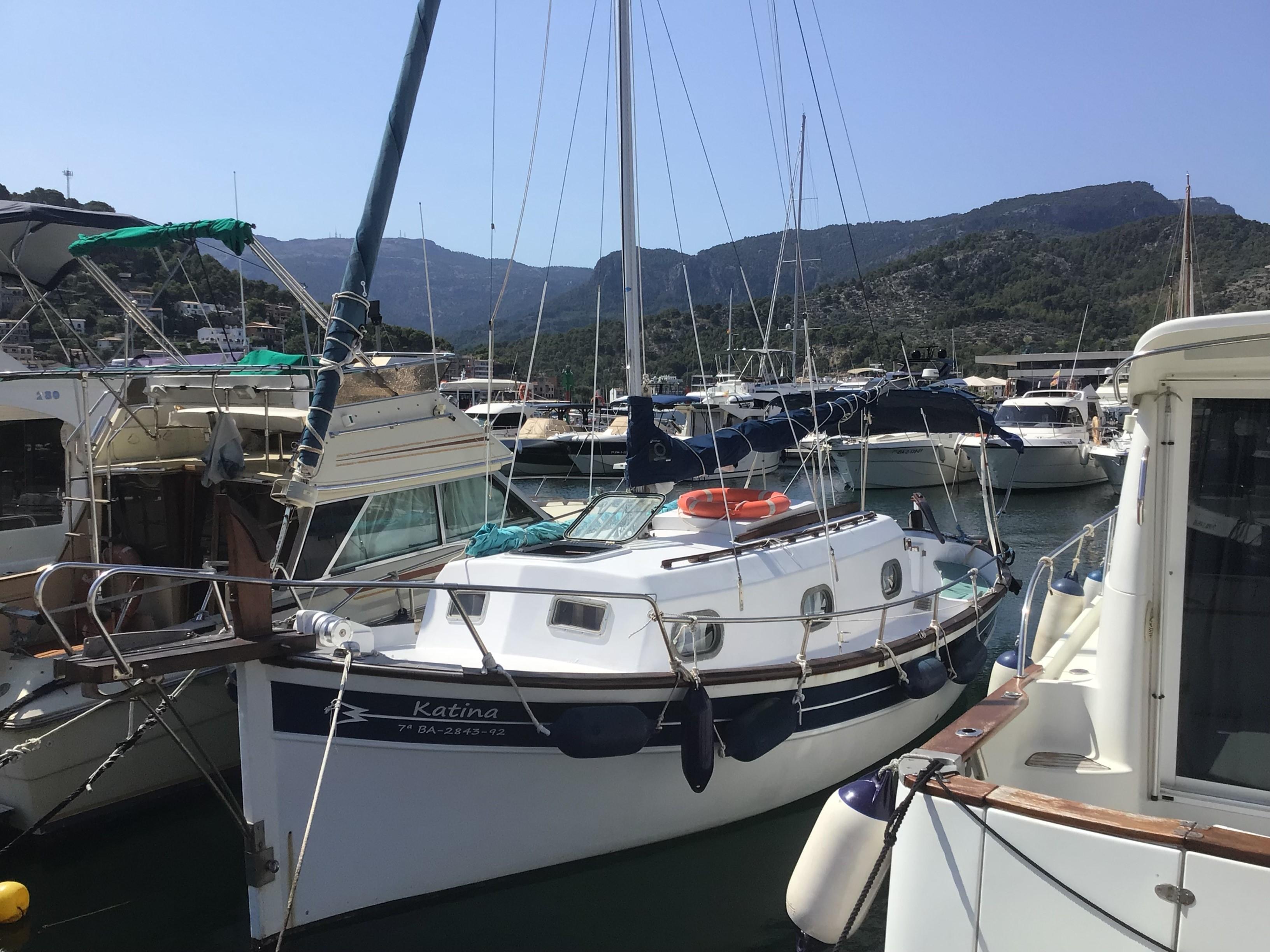 Myabca 26 1985 Myabca 26 boat docked in a marina with mountainous backdrop.